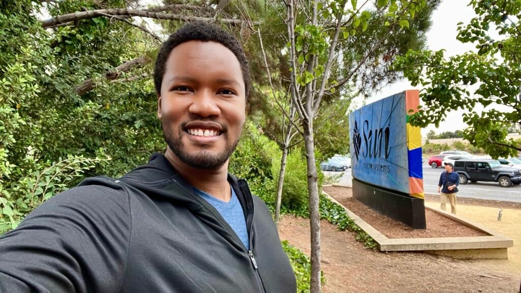 A self portrait of Mandlenkosi Vana outside the Meta headquarters sign whilst on his mindful travel adventure to the USA